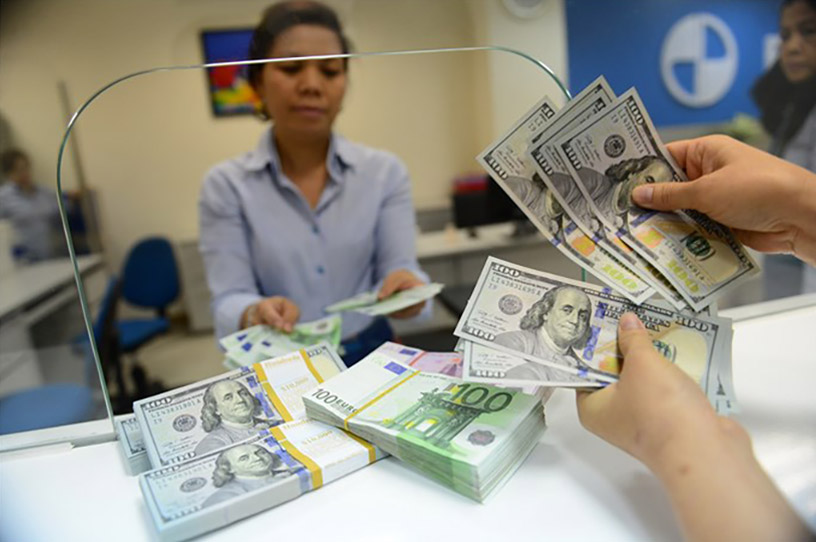 Exchange US dollars to Vietnamese dong at Vietnamese banks.