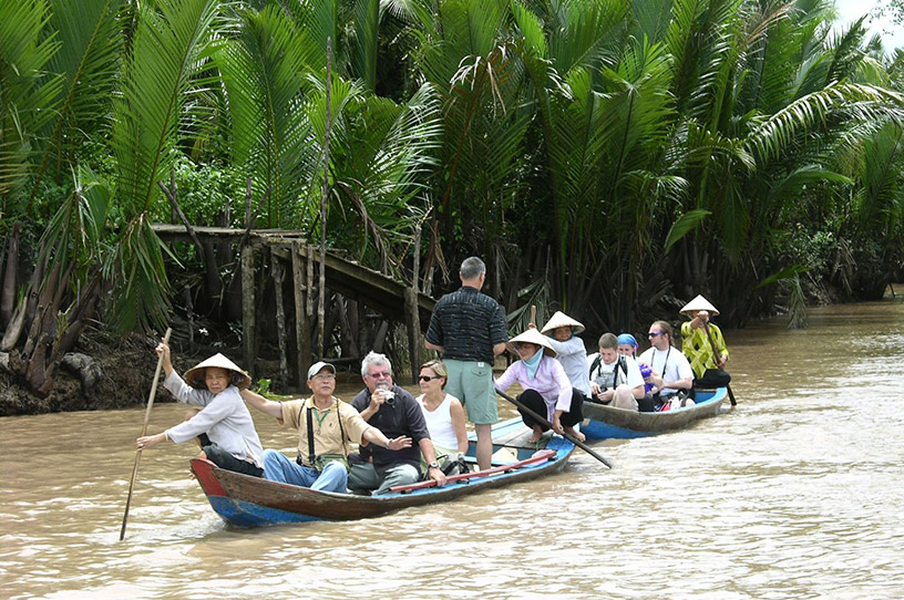 Tourists take a boat to explore Ben Tre